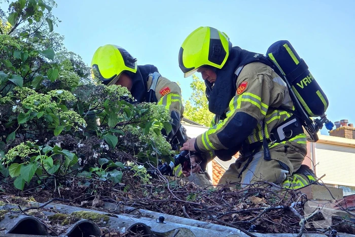 Brandweer blust brand in dak