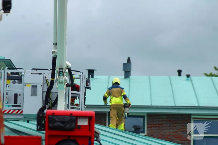 Rook uit dak van schoolgebouw