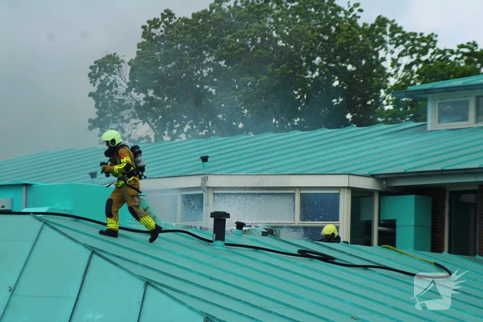 Rook uit dak van schoolgebouw