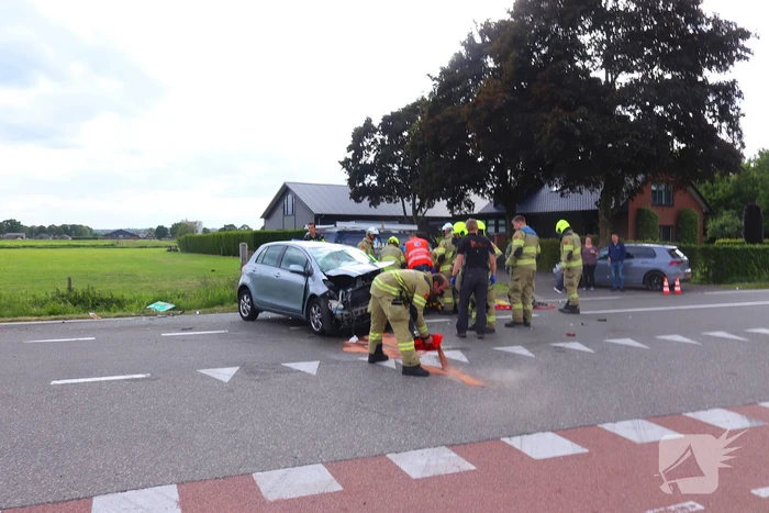 Bestelbus en personenauto met elkaar in botsing, brandweer assisteert bij bevrijding automobilist
