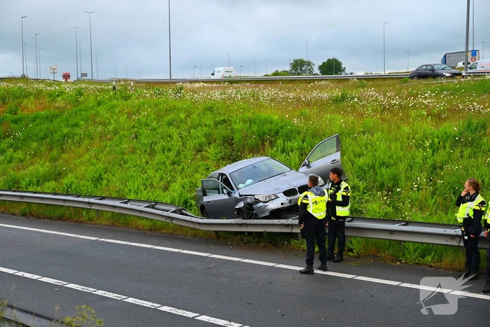 Auto crasht en belandt op vangrail