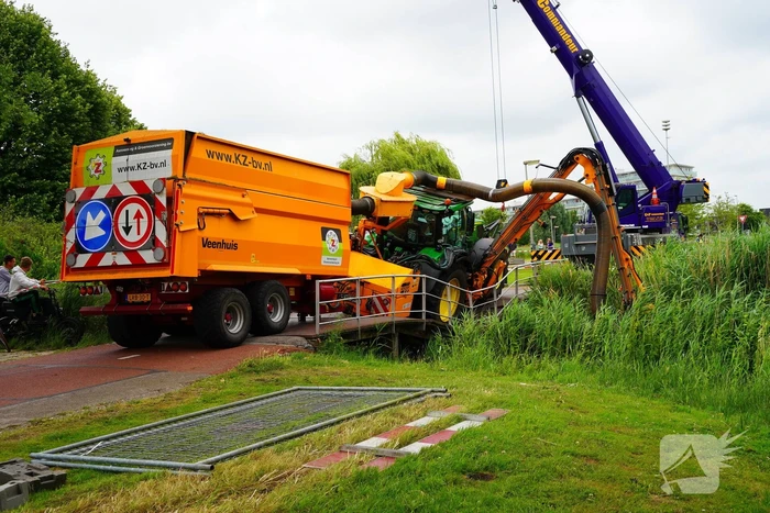 Tractor zakt door brug tijdens werk