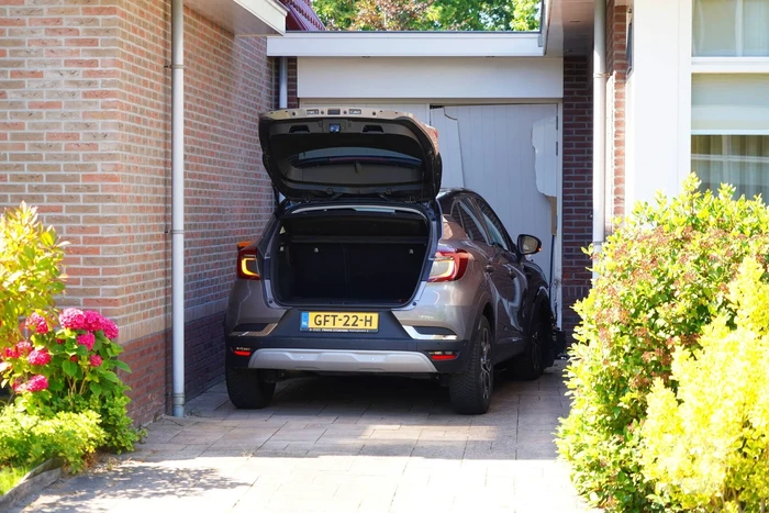 Auto rijdt garage binnen tijdens inparkeren