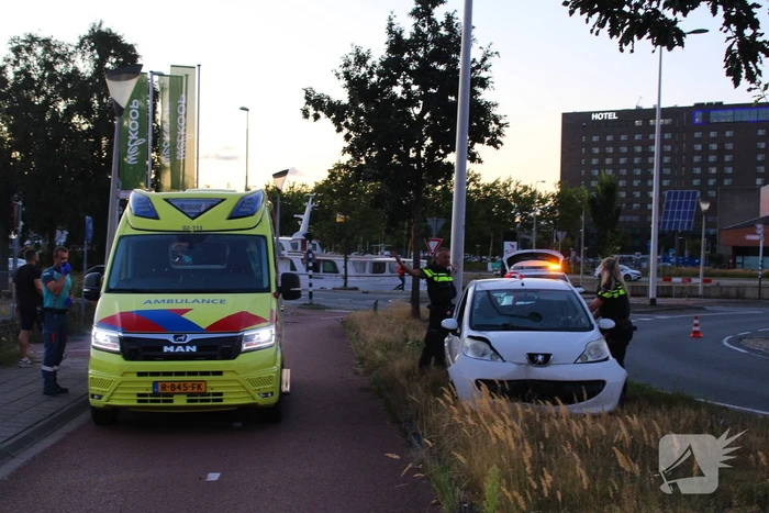 Auto crasht op rotonde en raakt paal