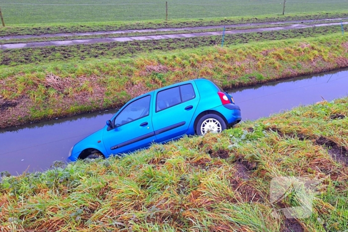 Auto te water door modderig wegdek