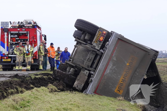 Vrachtwagen kantelt en belandt in sloot