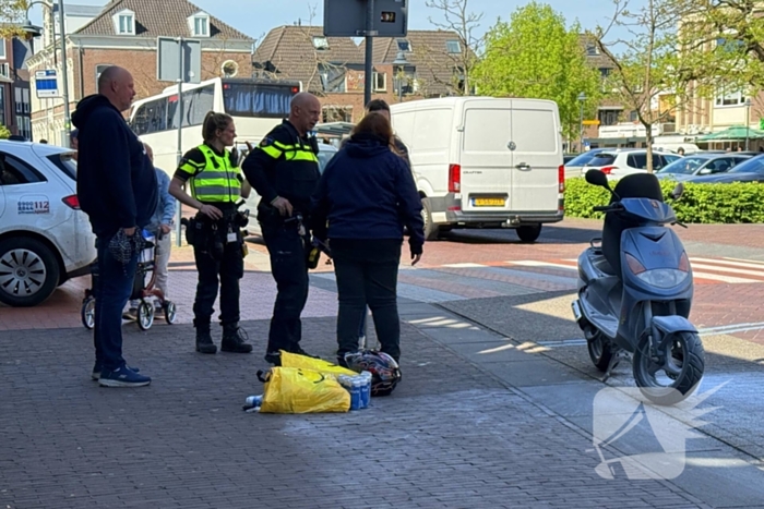 Omstanders blussen brandende scooter