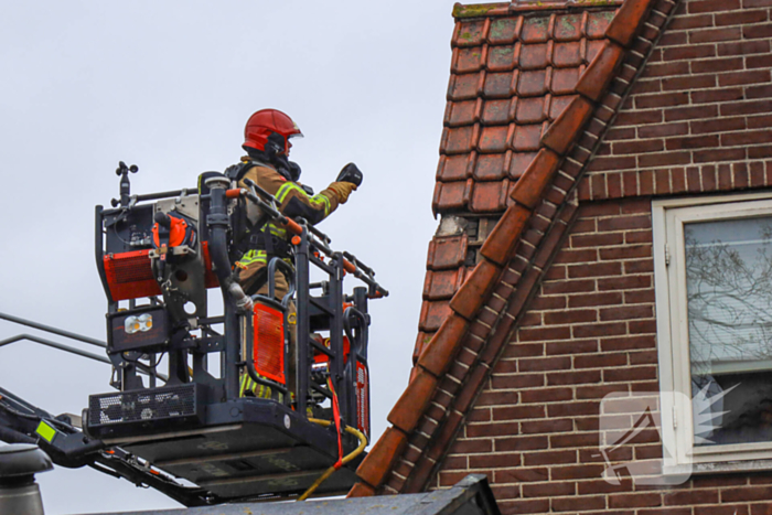 Brandweer blust brand op dak van woning