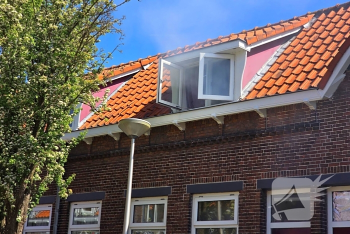 Brandweer slaat raam in wegens brand