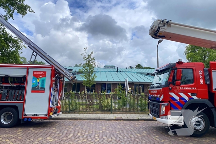 Rook uit dak van schoolgebouw