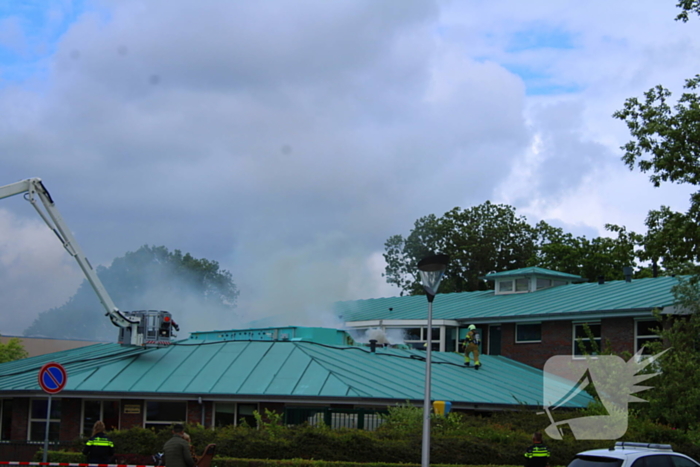 Rook uit dak van schoolgebouw