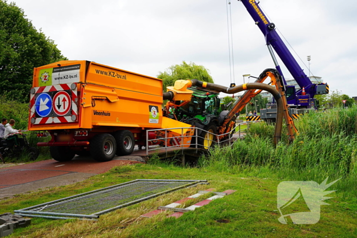 Tractor zakt door brug tijdens werk