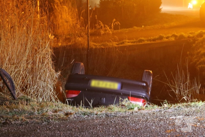 Auto belandt op de kop in het water