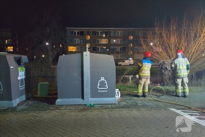 Brandweer blust brand langs sloot