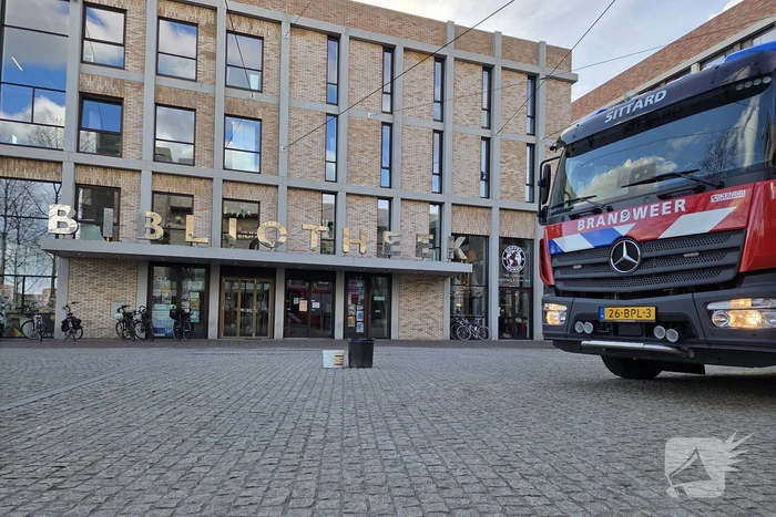 Verward persoon spuit met verf in bibliotheek