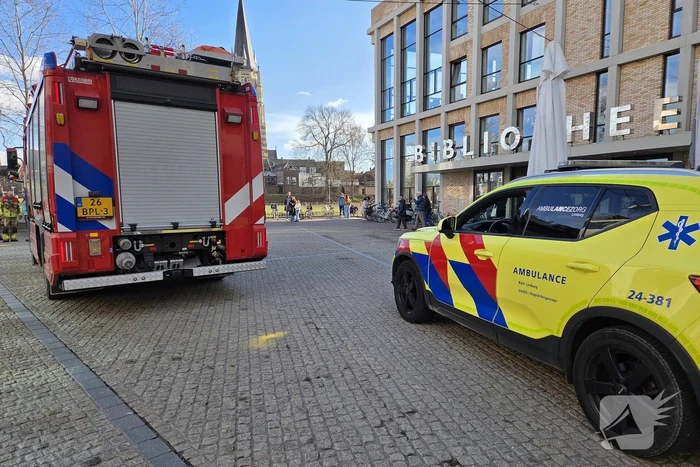 Verward persoon spuit met verf in bibliotheek