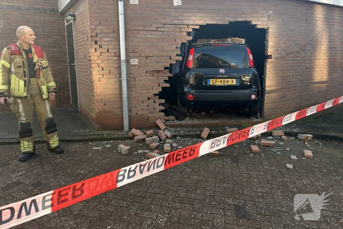 Vrouw rijdt dwars door muur van schuur