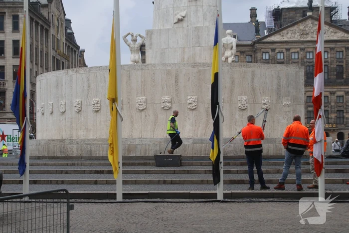 Schoonmaken van nationaal monument op Dam na bekladding
