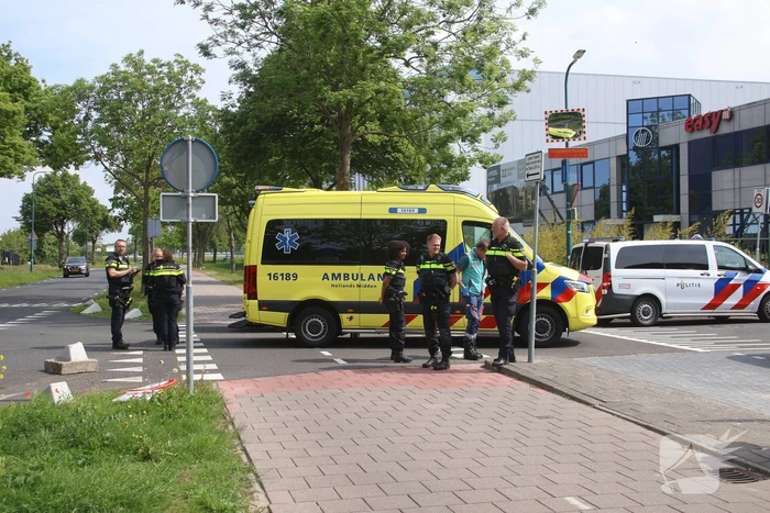 Omstanders halen inzittenden uit te water geraakt voertuig