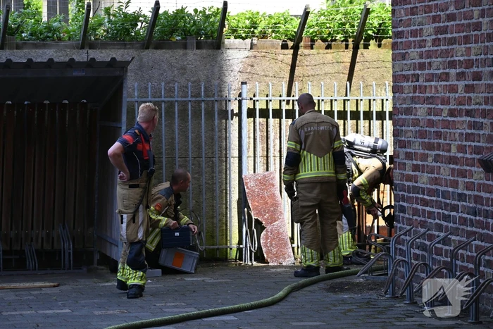 Vuur in houten schutting bij kerk