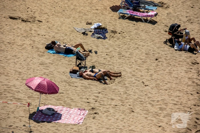 Mensen zoeken verkoeling aan zee