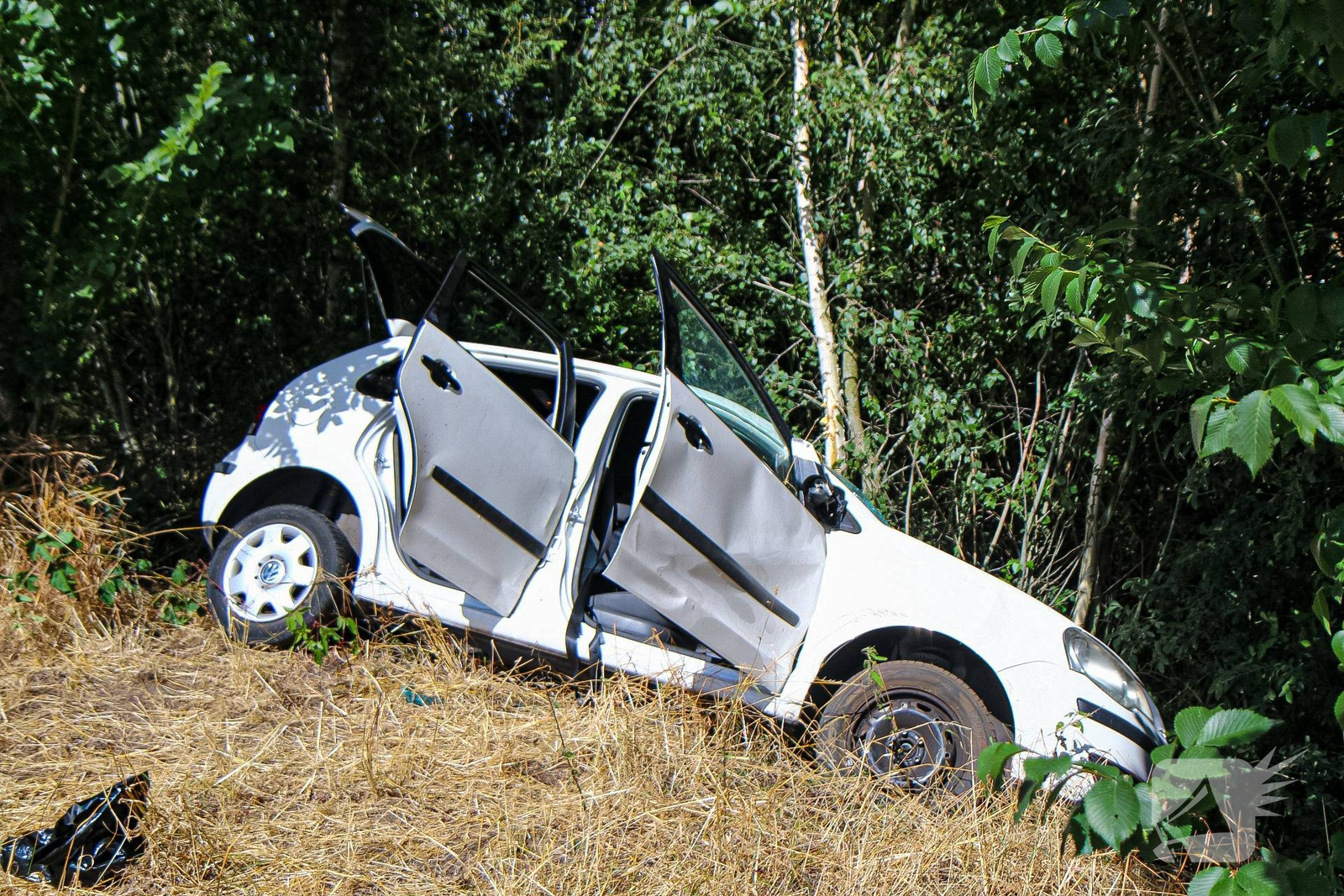 Auto botst door berm en hekwerk