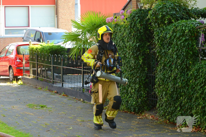 Rookwolken uit woning bij brand