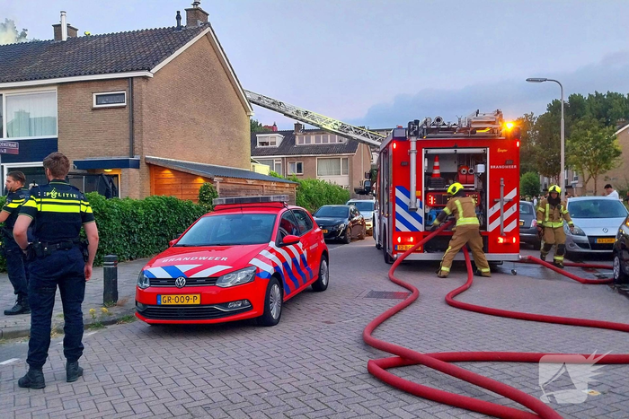 Dakkapel in vlammen, brandweer schaalt op