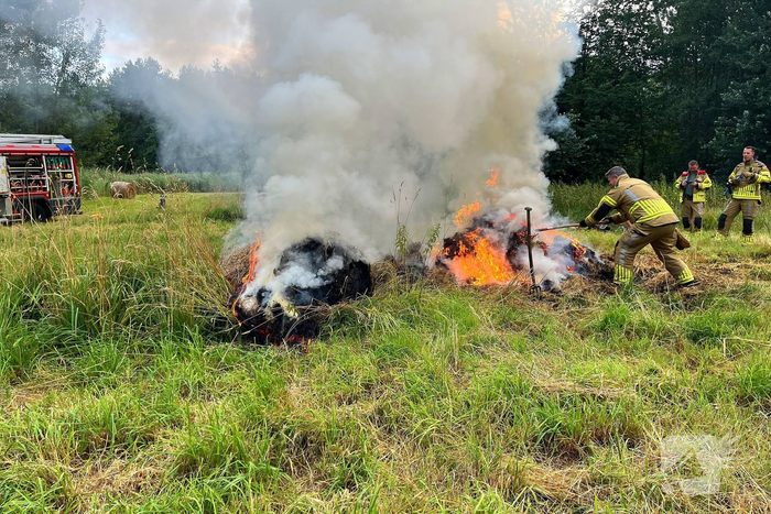 Brandweer blust brand in hooibaal