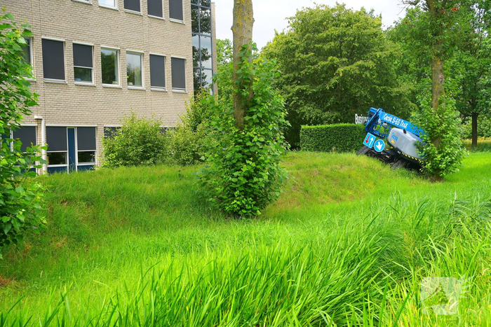 Hoogwerker komt in problemen naast bedrijfsgebouw
