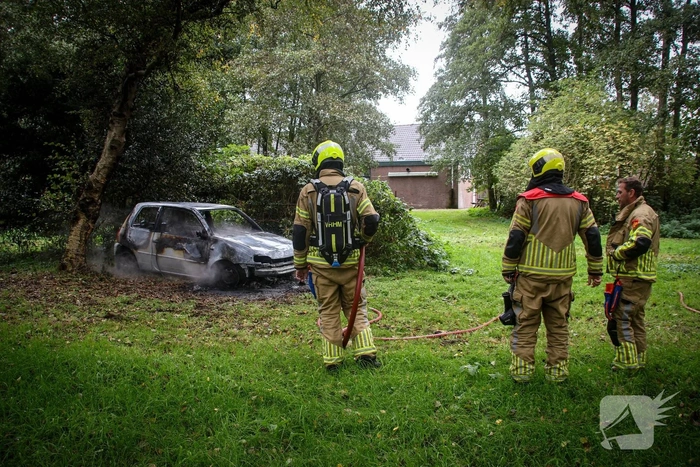 Personenauto volledig in brand tussen oude barakken