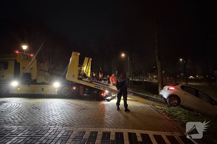 Personenauto belandt deels in water