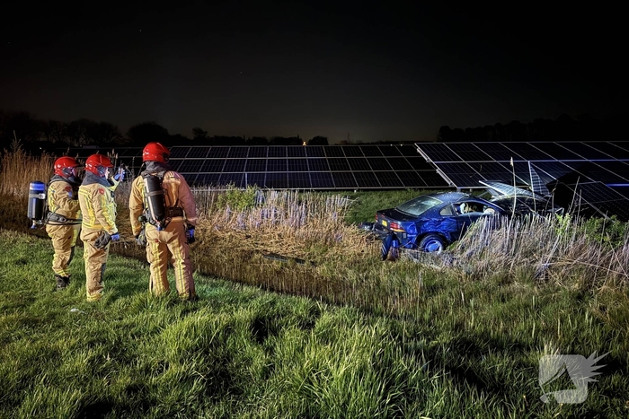 Auto boort zich in zonnepanelen na botsing met taxi
