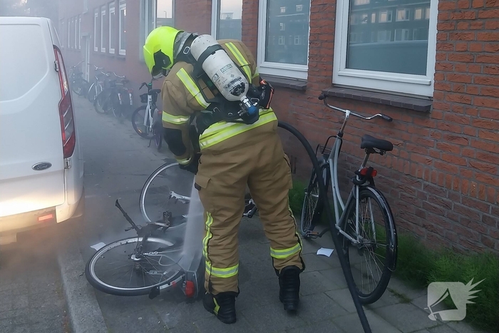 Fiets in brand tegen gevel van woning